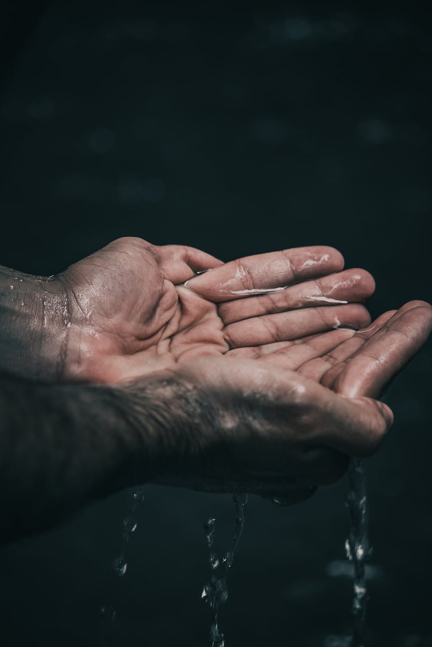 person holding water in cupped hands